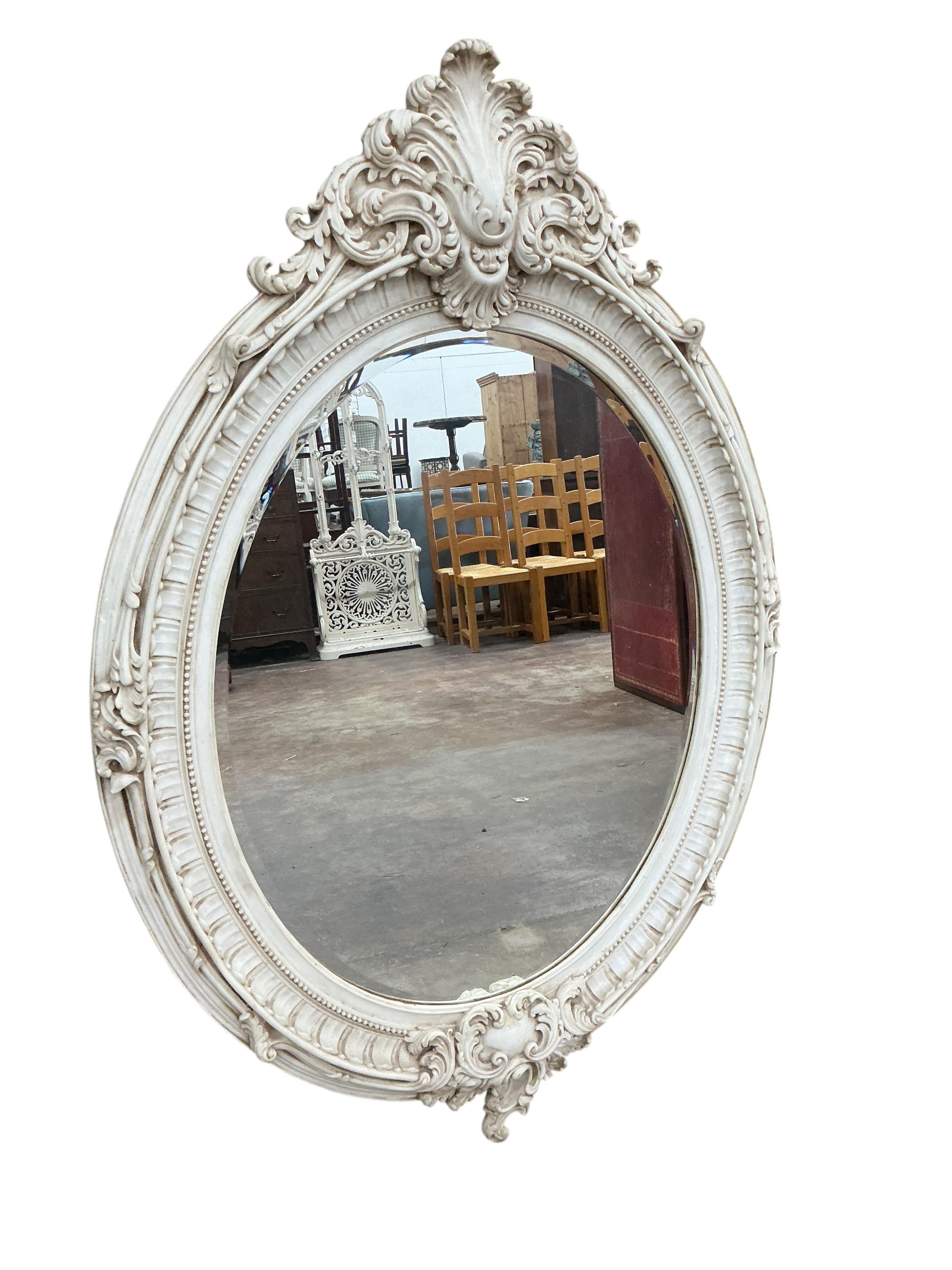 A Victorian style compostion faux marble oval wall mirror, width 104cm, height 148cm